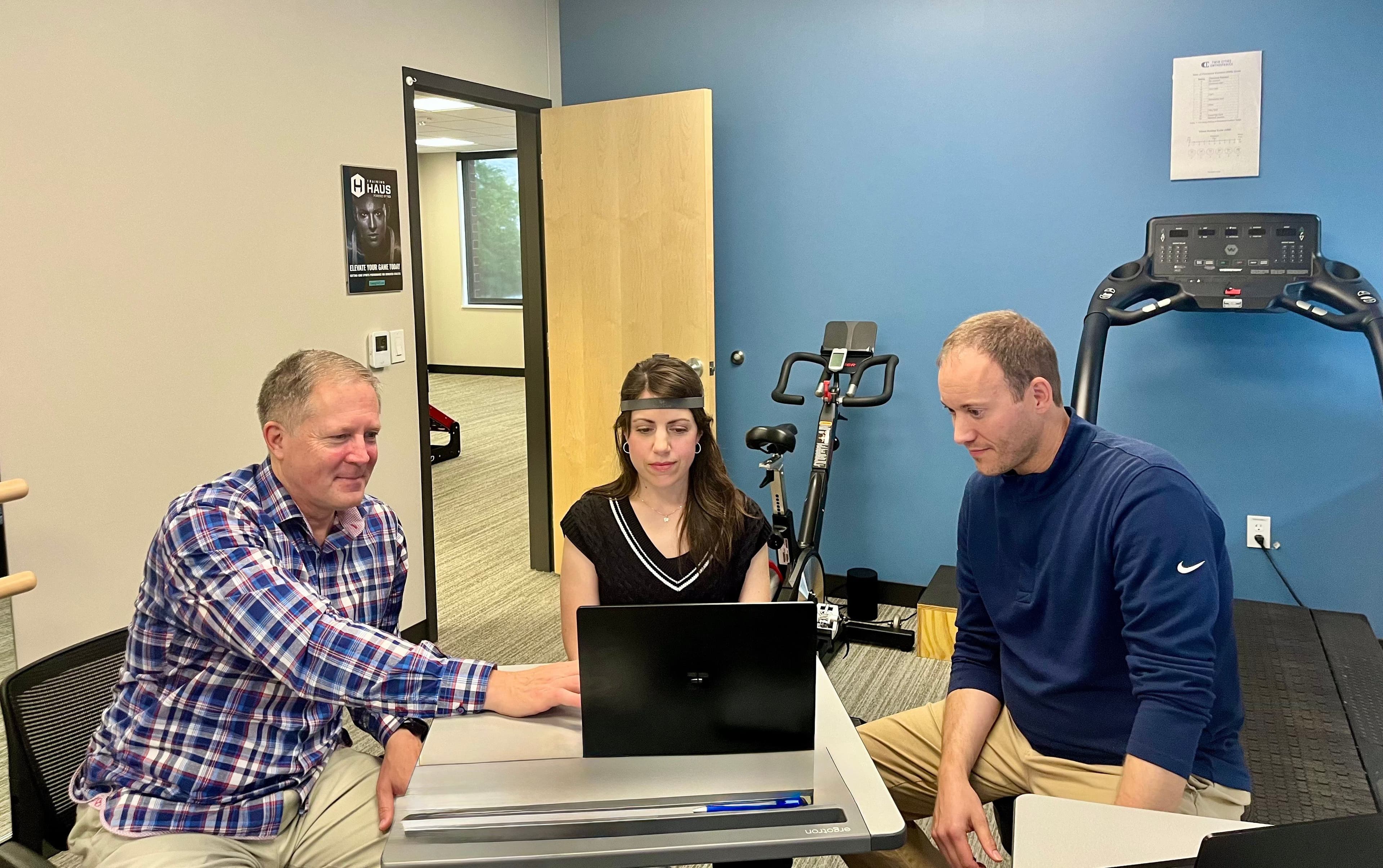 Clinician overseeing a patient conducting an assessment with the NeckCare System