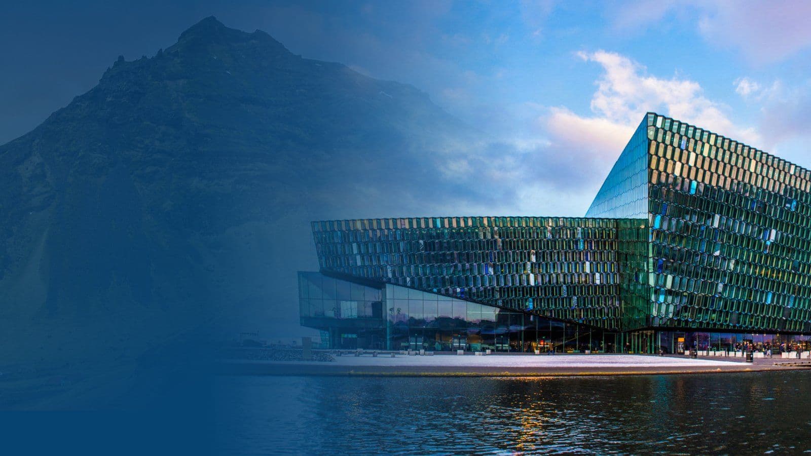 Harpa Conference Center on the Reykjavík waterfront with a mountain in the background